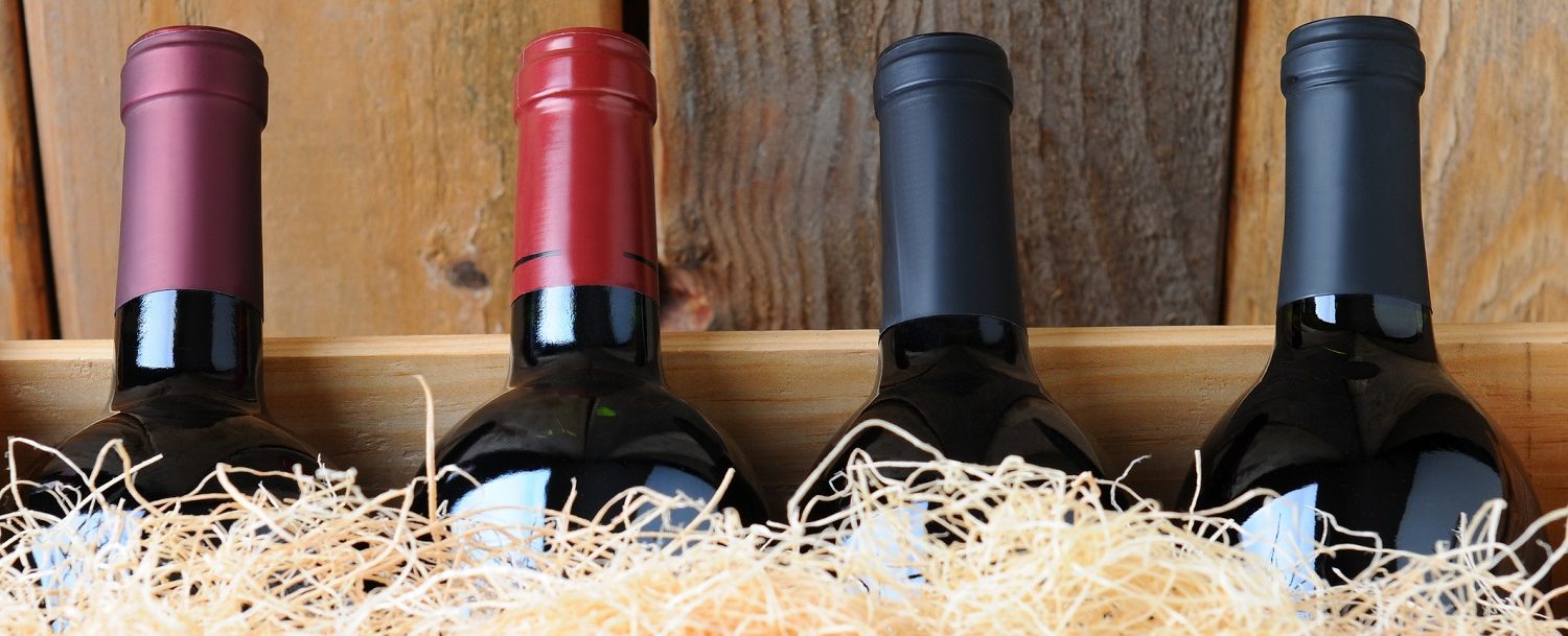wine bottles in a wooden box with straw